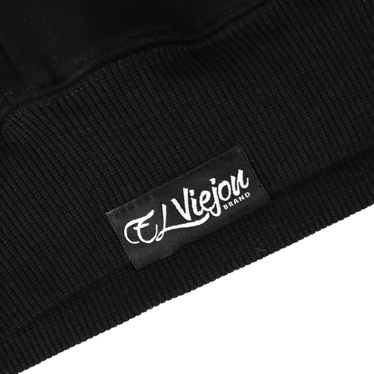 Close-up of a black cotton/poly fleece hoodie with a woven "El Viejou Brand" label.