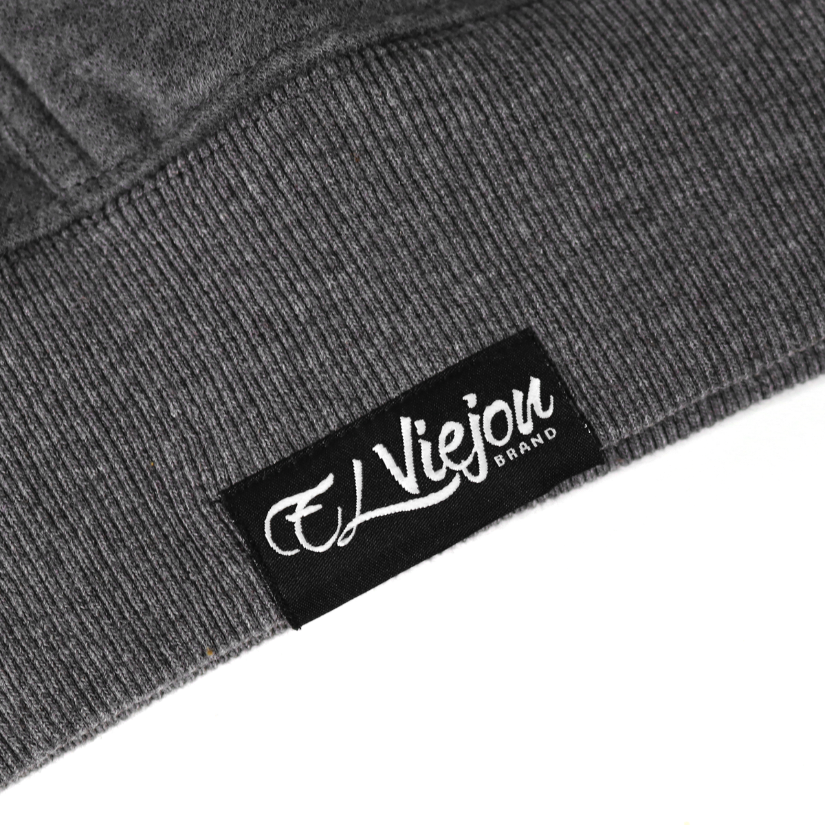 Close-up of a dark heather gray cotton/poly fleece hoodie with a black "El Viejou Brand" label.