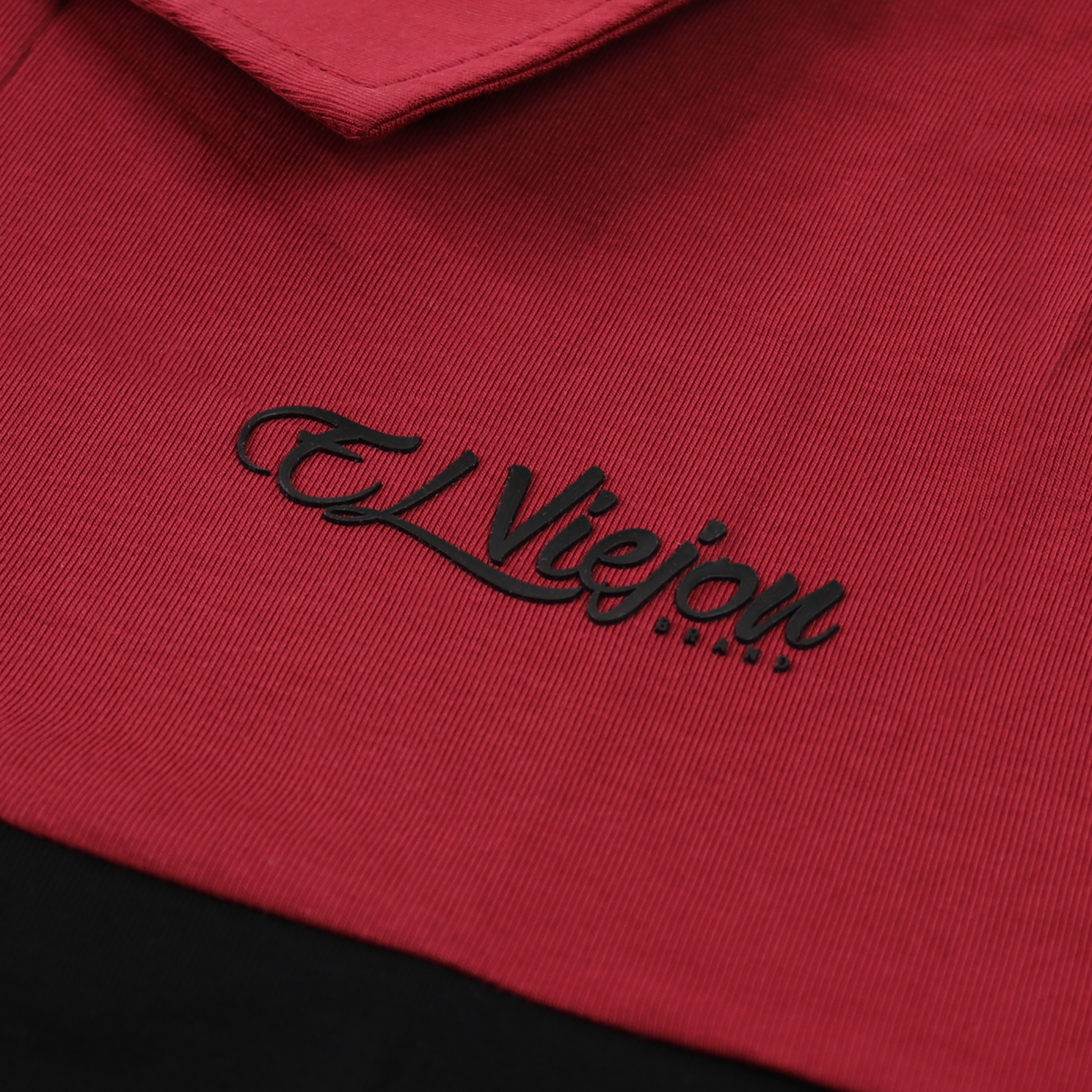 Maroon and black polo shirt with a black 3D "El Viejon Brand" logo and ribbed cotton-spandex fabric.