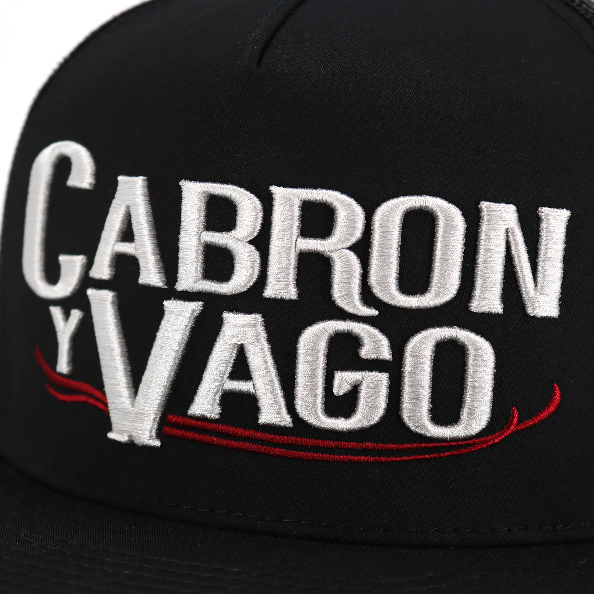 Cabron Y Vago black flat visor hat with silver embroidered logo and red accents.