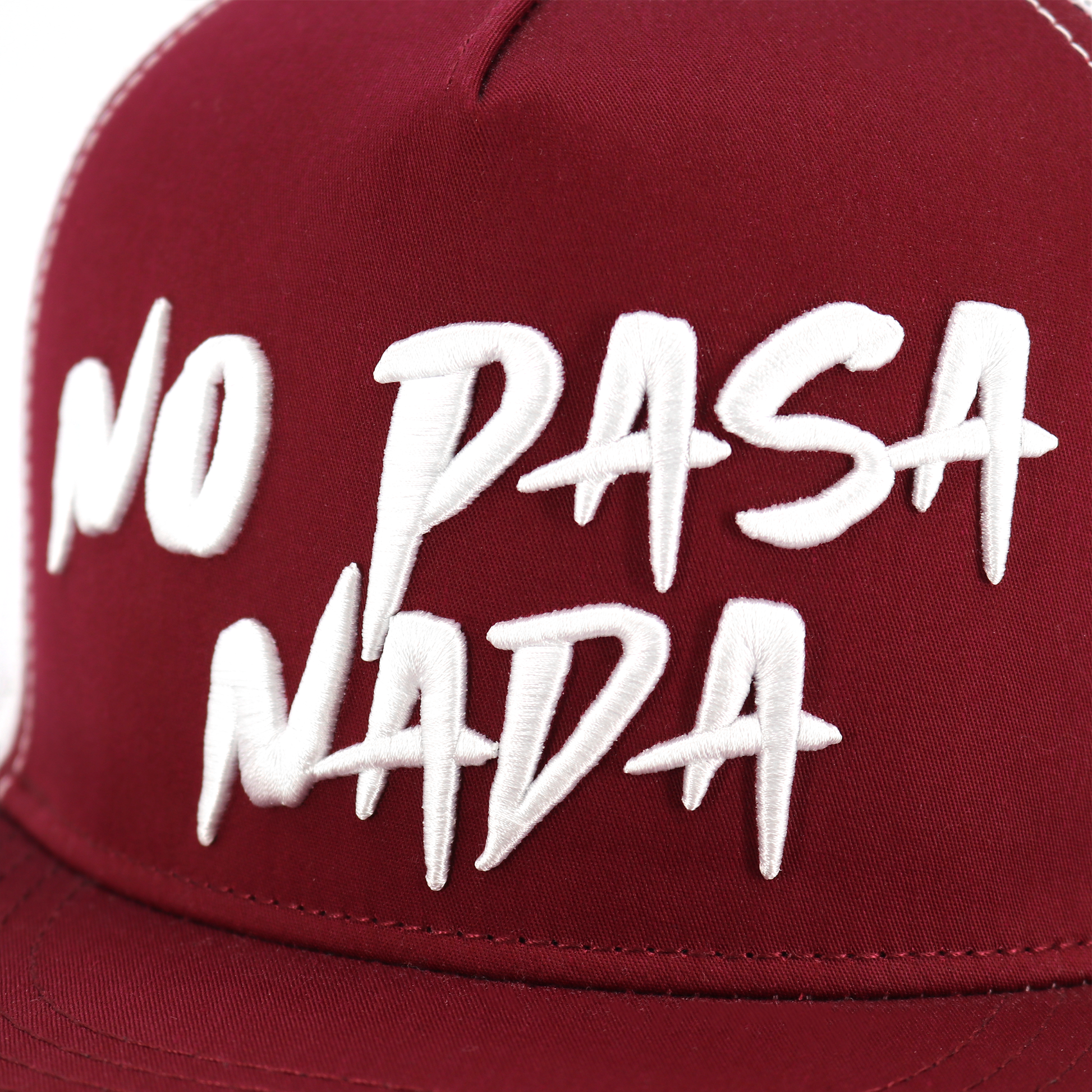 Maroon flat visor hat with "NO PASA NADA" embroidered in white, high profile, adjustable snapback.